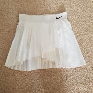 Nike Dri-Fit pleated white tennis skirt.   Size Small. Asymetric hem.